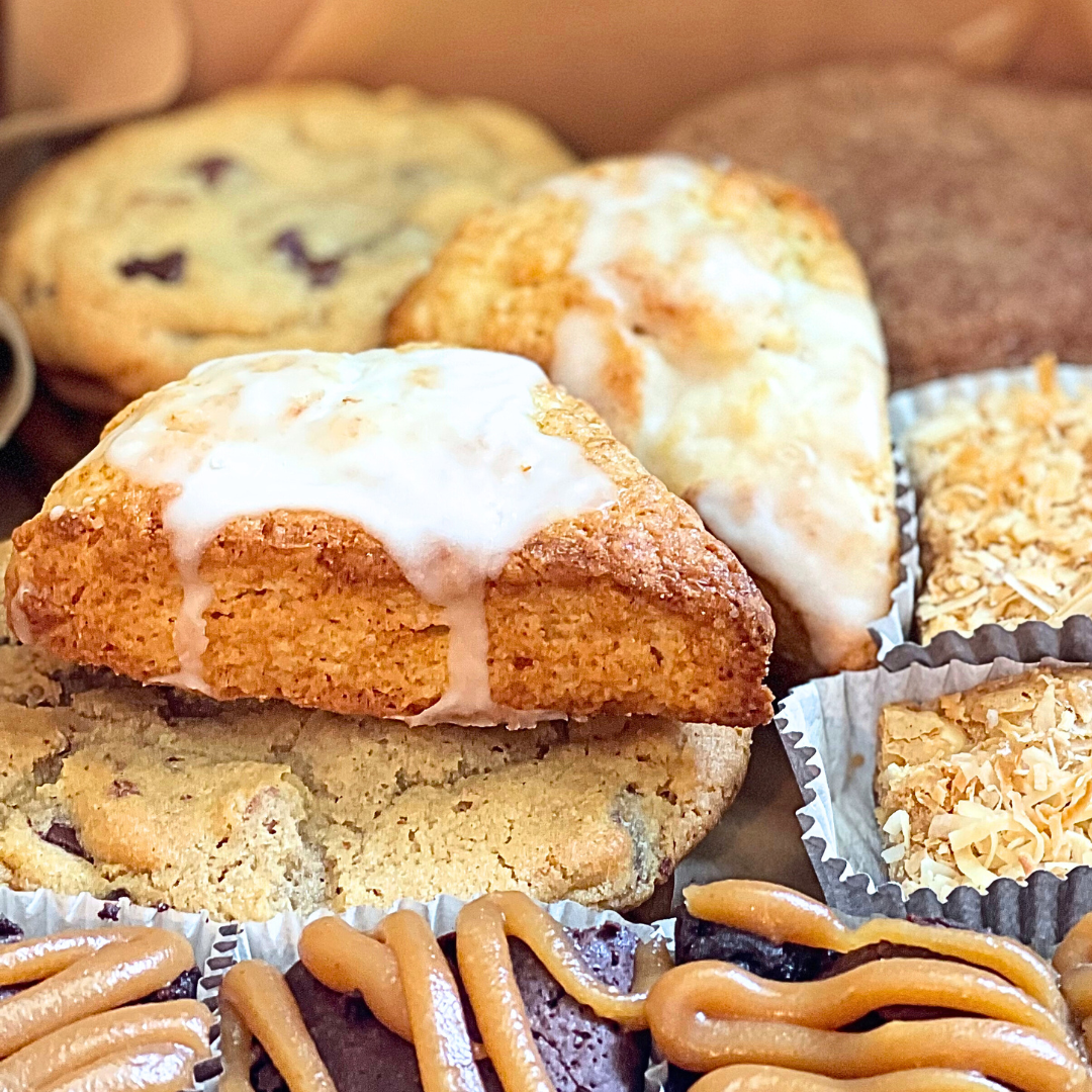 Assorted pastries including scones and muffins on a tray.
